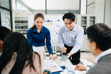 Creative Asian business people working on business project in office