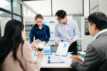 Creative Asian business people working on business project in office