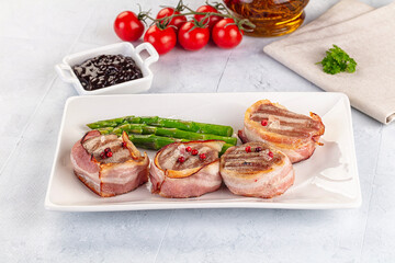 Tasty grilled pork medallion with bacon