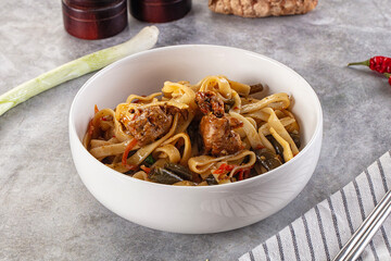 Asian cuisine udon with chicken and vegetables