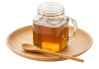Honey in a glass jar isolated on a wooden plate, natural sweetener for healthy eating and cooking ingredient