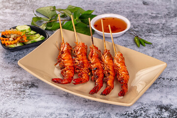 Grilled prawn skewer served sauce