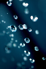 Close up of abstract floating bubbles water droplets condensation rain on a glass transparent bokeh background