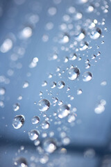 Close up of abstract floating bubbles water droplets condensation rain on a glass transparent bokeh background