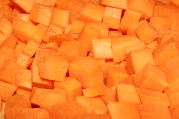Close up of cubed chopped and sliced carrots absrract background