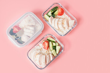 Glass boxes with rice, chicken fillet and vegetables on pink background, meal planning concept.