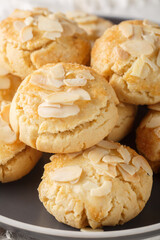 almond flake biscuits closeup on the plate on the table. Vertical