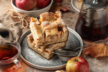 Homemade Apple Pie with fresh apples sliced on textured background close up. Thanksgiving traditional dessert, autumn baking, recipe