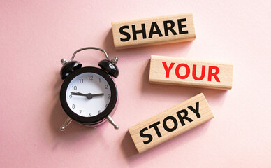 Share your story symbol. Wooden blocks with words Share your story. Beautiful pink background with alarm clock. Business and Share your story concept. Copy space.