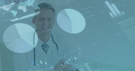 Smiling physician in lab coat and stethoscope analyzing data at clinic desk with digital charts