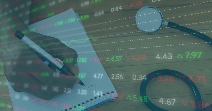 Doctor hand holding pen over spiral-bound notebook on desk with stethoscope and ticker overlay