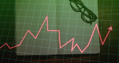 Naklejka premium Displaying red line graph arrow rising over grid overlay on office desk, with laptop eyeglasses