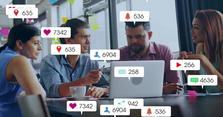 Team discussing social media data in meeting room, with laptop, sticky notes, notifications