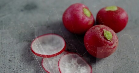 Arranging three red radishes and two radish slices on kitchen countertop, fresh produce © vectorfusionart