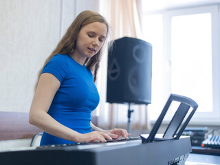 Caucasian woman playing electric piano. 