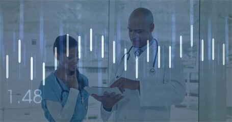 Pointing doctor with stethoscope and scrub nurse examining tablet in clinic corridor, data overlays