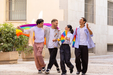 Diverse friends parading rainbow flag for lgbtq plus pride