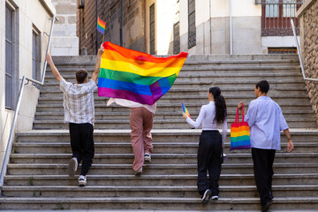 Group of friends celebrating pride on city stairs