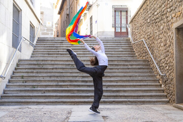 Dancer performing expressive movement with pride flag