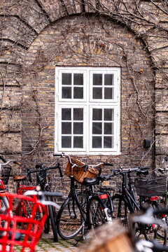 bicycle Copenhagen Denmark stone arch facade window architecture urban sustainable design row of bikes under historic masonry blending heritage with cycling culture.