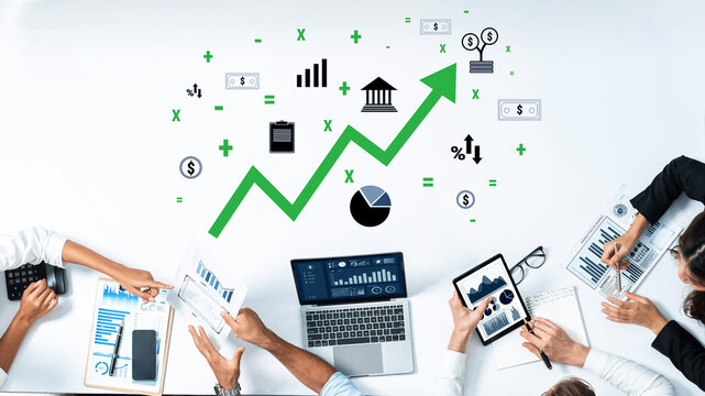 A dynamic business team collaborates on financial analysis, showcasing rising trends and relevant symbols, highlighting teamwork and productivity in a modern office. Trope