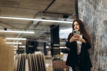Young Woman Taking a Picture with Her Smartphone in a Modern Setting