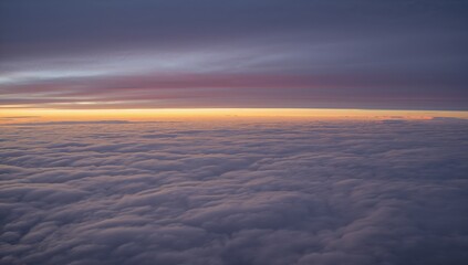Drifting high-altitude view capturing stratocumulus clouds filling lower frame with golden sunrise