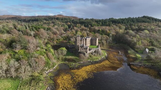 Aerial view of the historic Duart Castle stands proudly on a rocky outcrop, surrounded by the sea and lush greenery, Isle of Mull, Scotland.