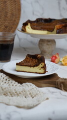 A slice of burnt cheese cake and a glass of coffee