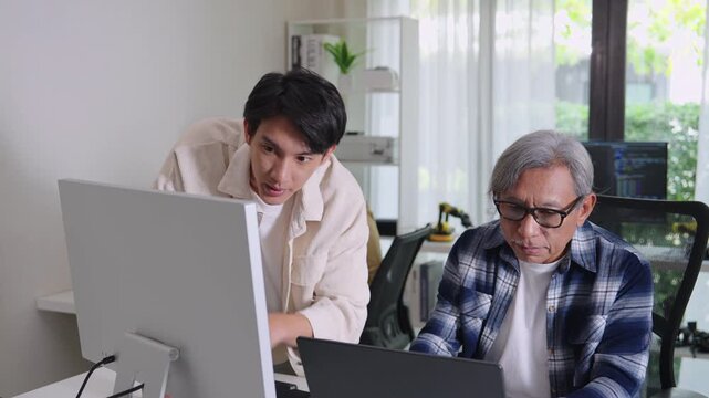 Group of asian senior in a collaborative software development analyzing  flowcharts  during a bootcamp training