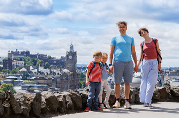 Father, mother and kids explore a city with iconic landmarks
