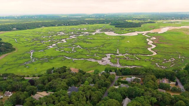 Drone video of Maine tidal marsh highlights curving channels, saltwater pools, and grassy wetlands meeting sandy banks, showcasing the rugged beauty of New England&rsquo;s coastal ecosystem.
