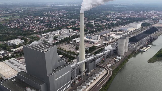 Grosskraftwerk Mannheim Aktiengesellschaft, energy production. Electricity from coals. Along the rhine river in Germany. Aerial video.
