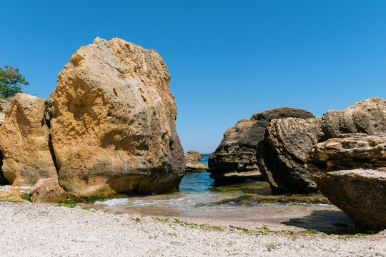Large limestone boulders on a sandy sea beach