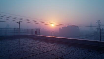 Glowing sun shining through mist on wet rooftop tiles, with wire mesh railing and power lines
