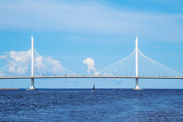 A lonely sailboat near the cable-stayed automobile bridge across the Gulf of Finland.