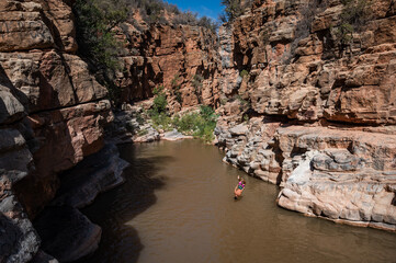 A man jumps headfirst into the water in a ravine. Paradise Valley in Morocco