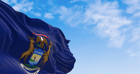 Michigan state flag waving in the wind on a clear day