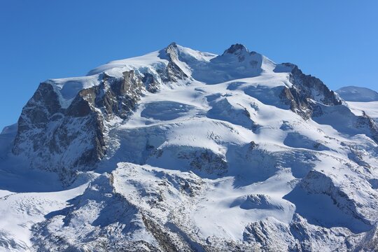 Panoramic view of the Monte Rosa Massif, Switzerland &mdash; a majestic snow-covered alpine landscape with glaciers and rugged peaks.