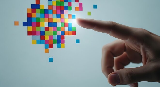 Finger touching a glowing cluster of colorful digital pixels forming a heart shape