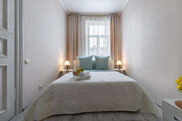 Minimalist Cozy Bedroom with Soft Lighting and Fresh Towels