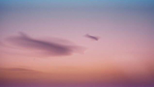 Floating large wispy cloud drifting across pastel twilight sky, with two wispy cloud formations