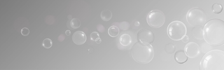 Transparent soap bubble or shampoo foam spheres floating on gray background for cosmetic or cleaning product design. Various glossy orbs and water droplets with ethereal effect and soft reflections.