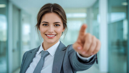 smiling female professional touching a virtual screen in a modern corporate office: a confident businesswoman in a gray suit and tie, symbolizing interaction, future technology, and success.