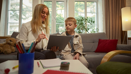 Female psychologist supporting boy during child therapy session in cozy office. Concept of child psychology, emotional support, healthcare communication, and educational materials for therapists.