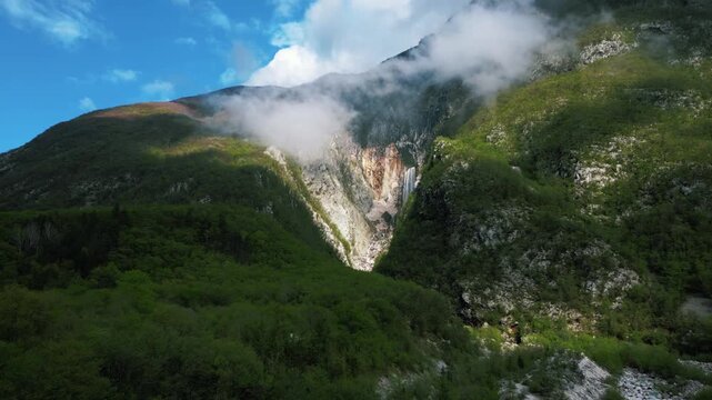 Drone flying towards the gorgeous tall waterfall on the mountain, Boka, Slovenia