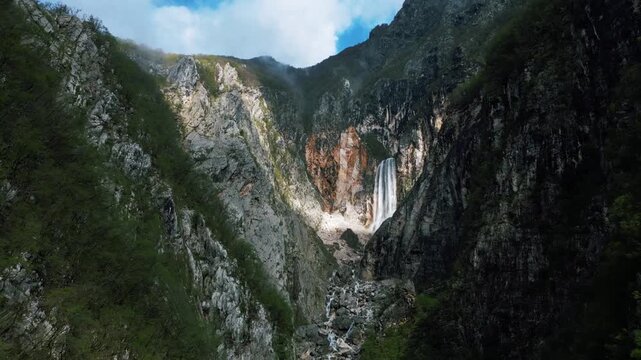 Boka waterfall on the side of the mountain, stunning high angle view, 4k