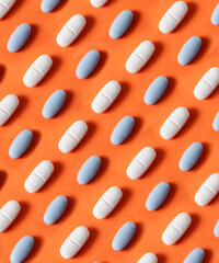 white pills on orange colored background