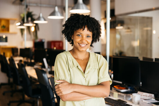 Woman smiling at office, confidence in business