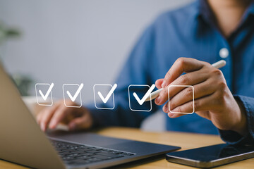 Checklist concept. Businessman using laptop. Checking mark on checkboxes.